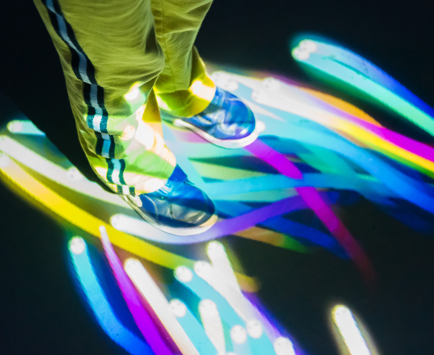 a child's feet caught in projected light at arboreal installation, built by Universal Live at Eureka! Halifax